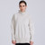 Woman wearing jumper in the colour Alabaster.  Woman wearing jumper in the colour Alabaster.