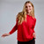 Woman wearing Country Laine - Merino Swing Jumper (CL0075) in the colour Blood Red. Woman wearing Country Laine - Merino Swing Jumper (CL0075) in the colour Blood Red.