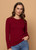 Women wearing Bordeaux coloured top