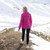 Woman wearing Moke - Lucy Cloud Touch Packable Down Jacket (LUCY) in the colour Rose Violet on a hill with snow in the background.