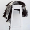 Alpaca fleece throw in Friesian colour draped on chair. 