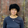 Woman standing wearing a Black coloured Four Peaks Classic Panelled Lambskin & Possum Fur Hat.
