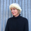 Woman standing wearing a Cream coloured Four Peaks Classic Panelled Lambskin & Possum Fur Hat.