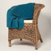 Pacific-coloured Koru Merino and Possum Diamond Throw draped over chair.