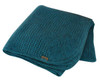 A folded pacific-coloured Koru Merino and Possum Diamond Throw.
