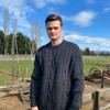 Man wearing Lesley Unisex Aran Wool sweater in the colour Charcoal.