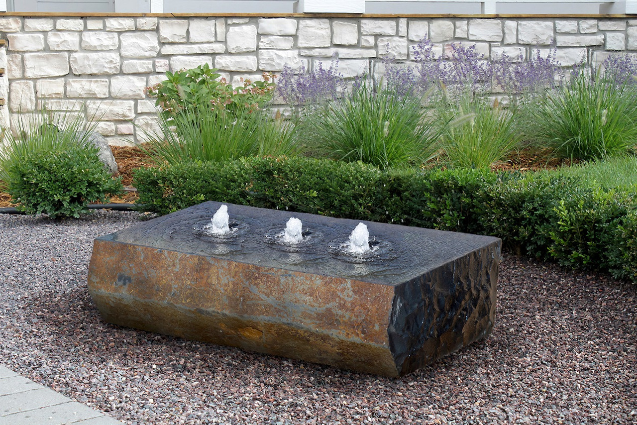 This monolithic fountain offers commanding presence, with 3 drilled holes allowing water to flow smoothly over its polished top. Chisled dark sides and a natural face compliment any landscape this fountain resides in.