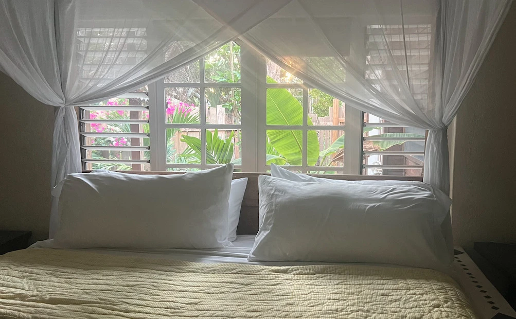 King cotton box bed canopy at Katamah Beachfront Guesthouse, Treasure Beach, Jamaica