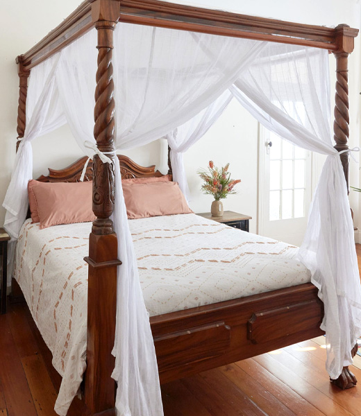 Four poster bed canopy curtains draped on a four poster bed
