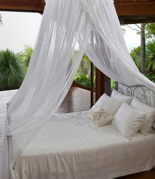 Round bed canopy suspended above a bed from a single point