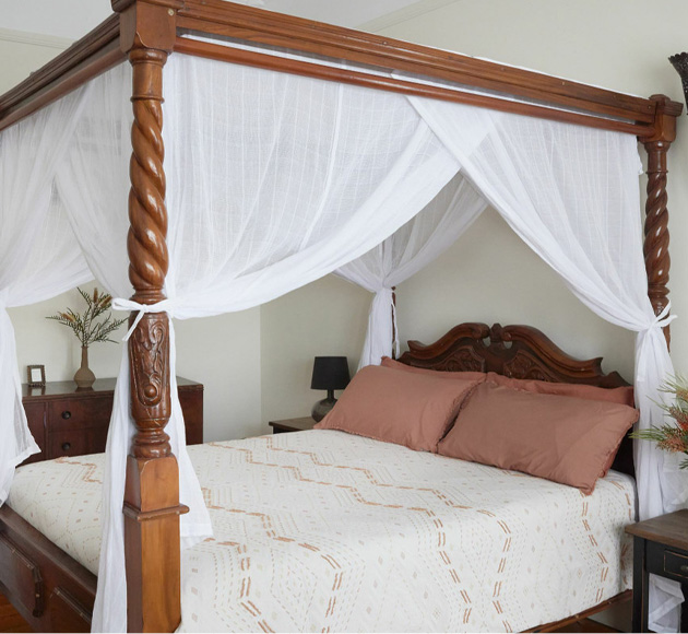 King and California King bed canopy curtains draped on a four poster king bed