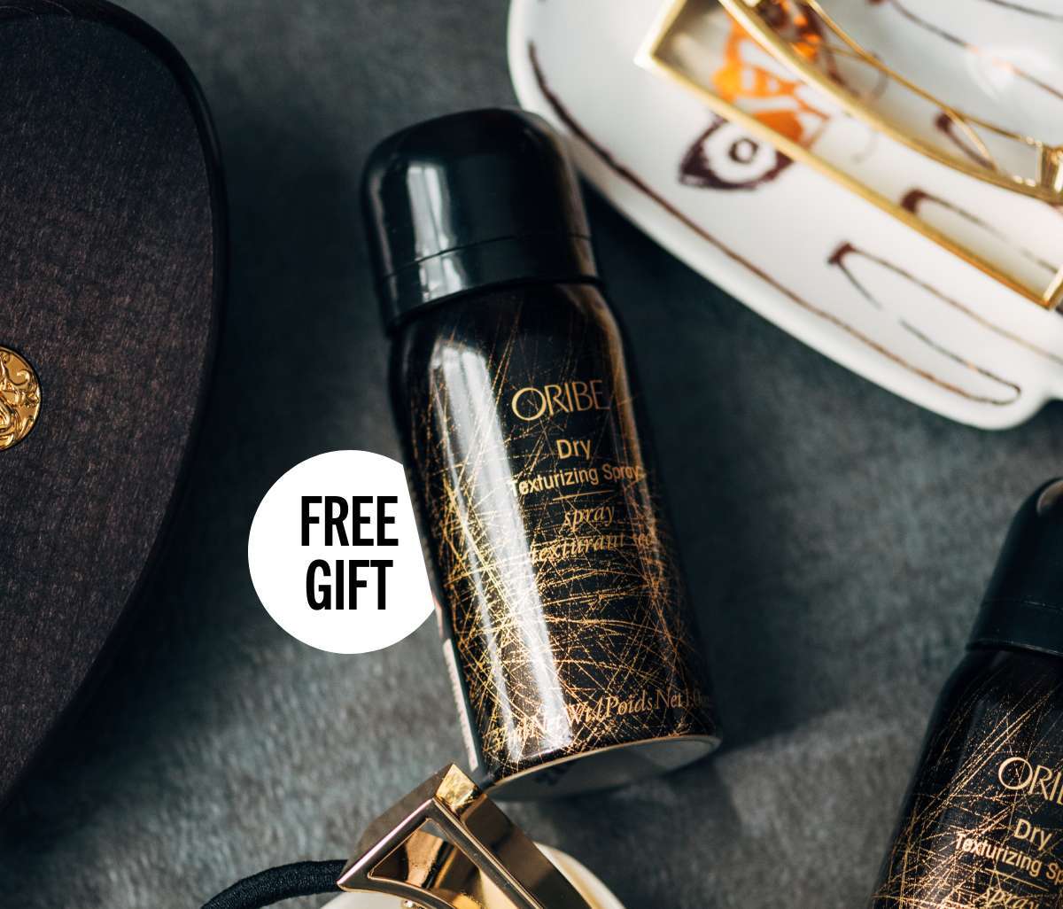 Free Oribe Dry Texture Spray Mini with purchase.*