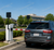 Automobile entering gated community using HID windshield-mounted RFID credential holder for secure vehicle access