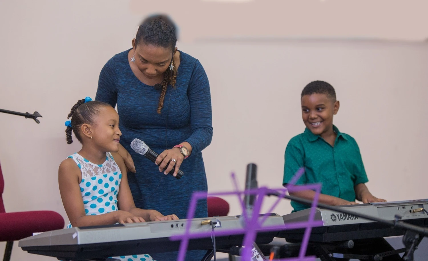 Lisa D de Quiñones guiding voice and keyboard work with Alabanza MusicVersity students
