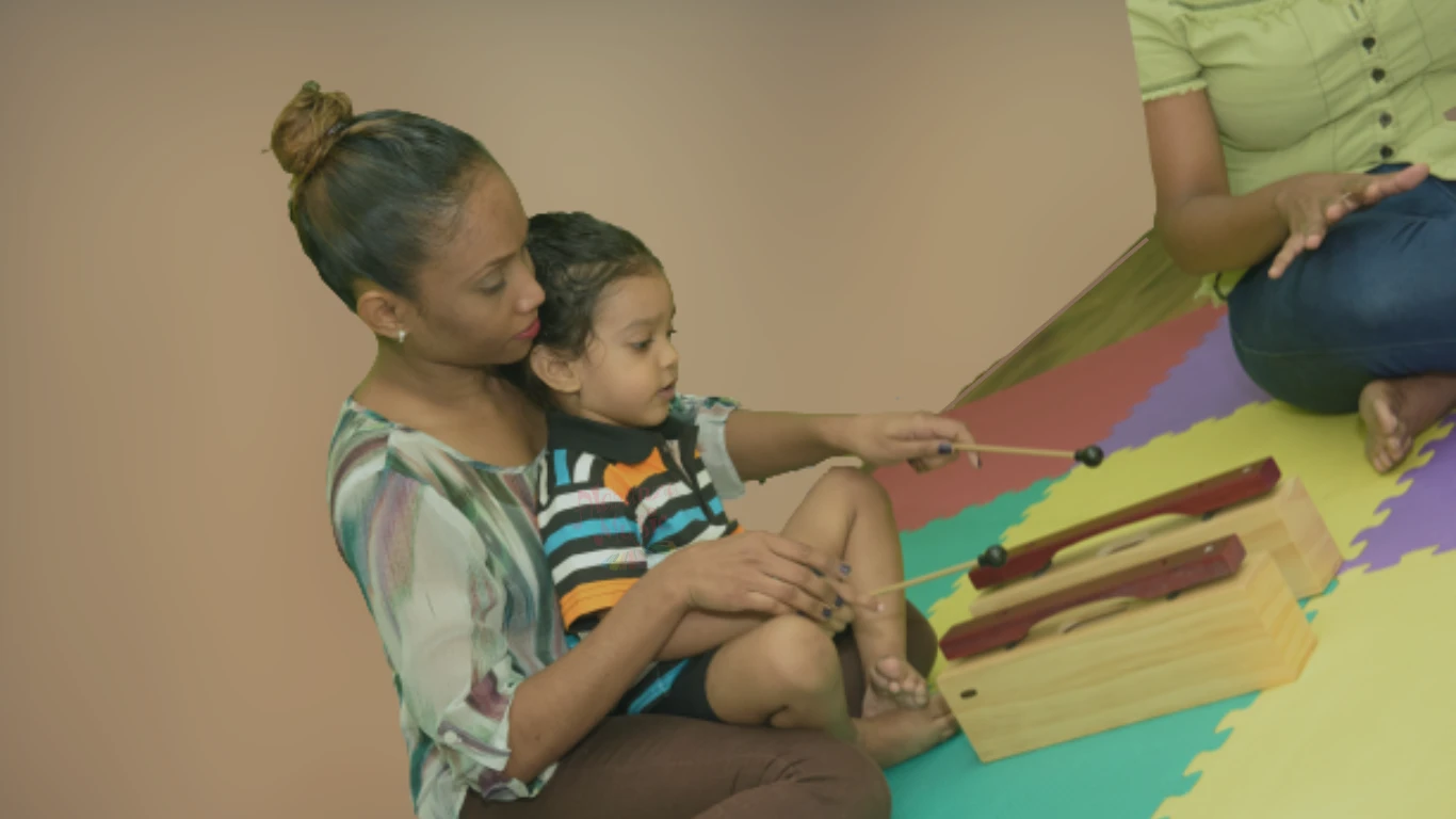 Parent and child exploring a resonator instrument