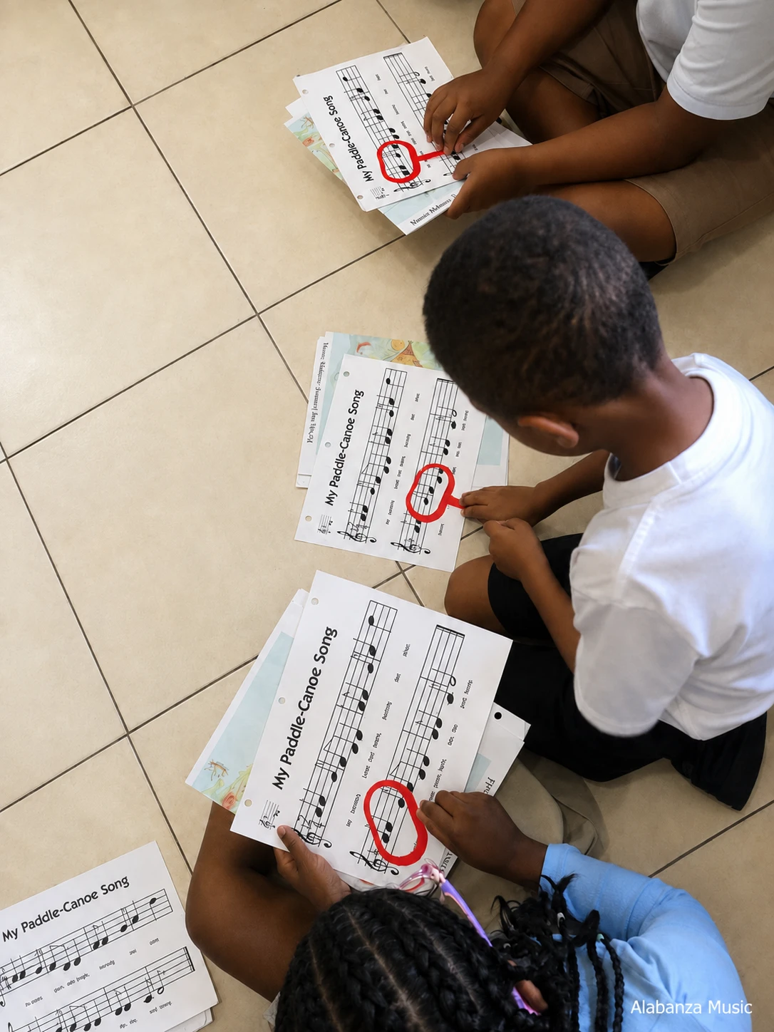 Primary-age student building ensemble and music literacy skills