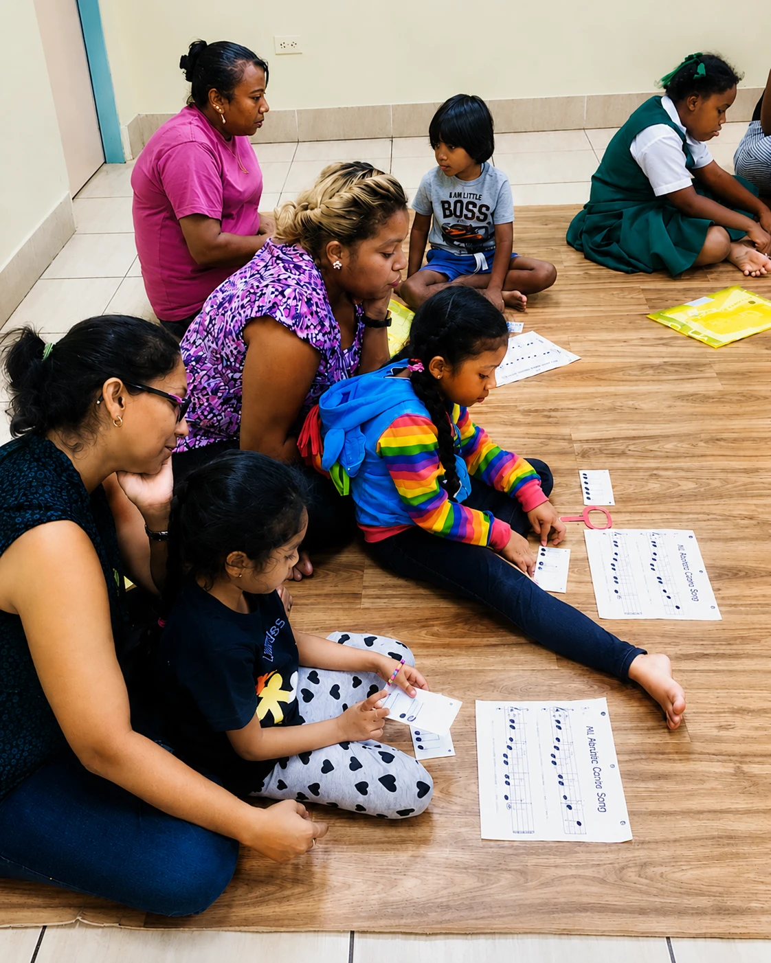 Parent participating alongside child in an Intro to Piano and Voice Mundo class