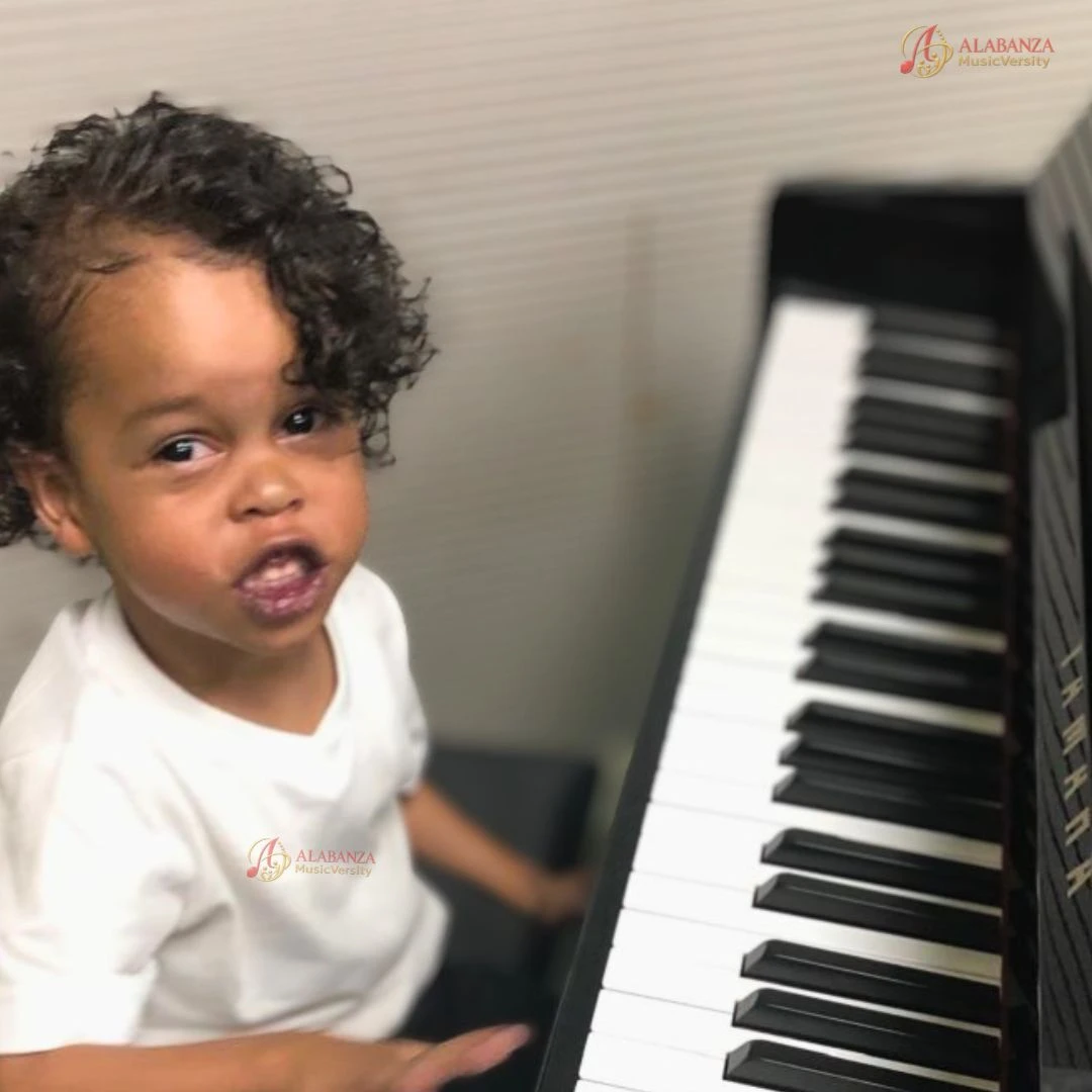 Preschool-aged child seated at a piano