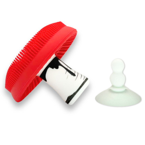 Underside of silicone mushroom scrubber displaying suction base for standing storage.