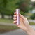 Lipstick spray in hand