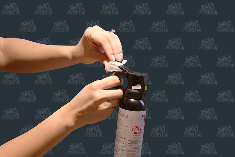 Removing Safety tab from bear spray cannister