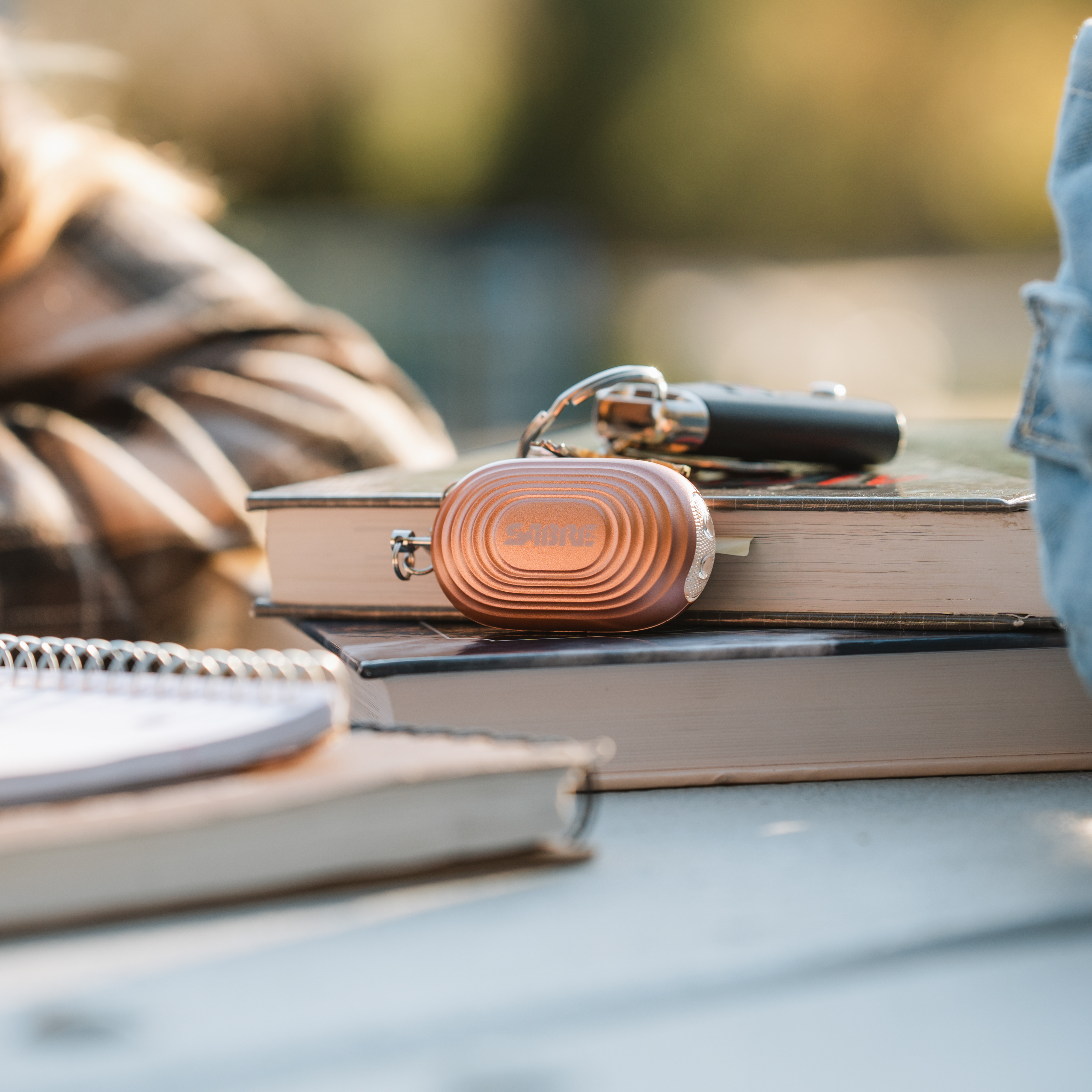 personal alarm next to books