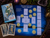 Thoth Tarot Premier Edition box beside the Ancient 10-Card Tarot Spread chart, with two Thoth cards, a purple candle, amethyst cluster, greenery, and mystical altar décor.