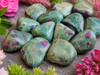 Close-up of polished Ruby in Fuchsite tumbled stones highlighting vivid ruby inclusions and unique natural patterns.