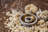 Frankincense Resin burns on a lit charcoal block in a stone bowl that is surrounded by loose frankincense tears with two bowls in the rear filled with frankincense.
