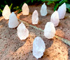 a closeup several rose quartz natural state standing crystals are on brickwork in filtered sunlight. Rose quartz is the ultimate stone of unconditional love, offering gentle emotional healing, heart chakra activation, and a calming energy that nurtures compassion, self-love, and spiritual harmony.