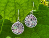 Sterling silver and abalone shell tree of life earrings dangle from French hook ear wires. These earrings are not just a statement of style but also a testament to inner strength, harmony, and spiritual elevation. .