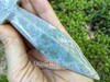 Moss agate athame resting on a cupped palm showing fine blade detail and rich green hues with rock and greenery behind. Moss agate athame resting on a cupped palm showing fine blade detail and rich green hues with rock and greenery behind.