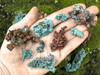 Assorted native copper specimens viewed from above in an open palm, revealing the raw structure, shape, and color variety of Moroccan copper. Assorted native copper specimens viewed from above in an open palm, revealing the raw structure, shape, and color variety of Moroccan copper.