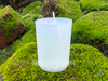 one sage bundle handmade votive candle sit on moss covered brick shown from the front displaying the candle beauty.