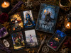 Top-down view of the Witches Tarot deck, companion guidebook, tarot cards, crystals, candles, dried botanicals, and ritual tools arranged on a dark wooden tabletop in a witchcraft-inspired setting.
