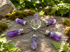 Amethyst crystal grid generator with a natural quartz sphere and six amethyst points, shown from the front. Perfect for meditation, crystal grids, altar décor, and spiritual practice.