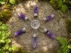 Amethyst crystal grid generator with a natural quartz sphere and six amethyst points, shown from above. Perfect for meditation, crystal grids, altar décor, and spiritual practice.