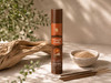 Desert Oudh handcrafted natural incense sticks in a 50-gram package displayed with loose incense sticks, incense powder, and natural driftwood in warm natural sunlight.
