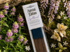 Single pack of Sacred Mists Shoppe incense lying on a bed of mossy botanicals.