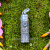 Front view of .925 sterling silver prayer bottle pendant with faceted Blue Topaz, scrolling silverwork, removable cap and large pendant bail.