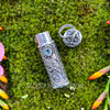 Sterling silver Blue Topaz intention bottle pendant with removable cap placed beside the vial, showing the opening and decorative cap design.