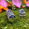 Close-up of the open Amethyst prayer bottle bottom displaying the .925 silver stamp and removable sterling silver cap with decorative scrollwork sits next to it.