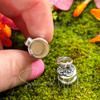 Open sterling silver Amethyst intention vial with removable cap, showing the hollow chamber for a written prayer or affirmation.