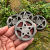 Silver Sheen Obsidian crystal pentacle altar tile held in hand, showing its carved openwork star and natural silvery gray sheen.