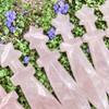 Detail view of Rose Quartz crystal athame handles and upper blades showing polished pale pink stone and star-shaped pommels.