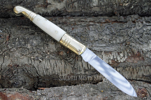 Folding boline ritual knife open resting on bark. Perfect for gardening, herbalist, candle inscription.