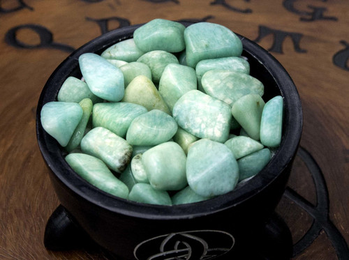 a black bowl of amazonite showing color variations as well as markings and possible inclusions. Perfect for harmony, communication, peace, overcoming fears, and growth.