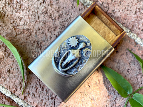 The Serenity Goddess adorns the front of this beautiful pocket-sized steel and birch wood box. This small box is perfect for carrying a few small stones or other treasures in. Included inside your treasure box are some of our blessed offering stones. You can buy these by the pound to refill your treasure box time and again as you leave offering stones in your travels and wanderings, right here at Sacred Mists Shoppe.