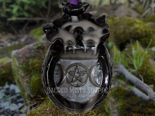 Close-up of the Triple Moon Pentacle Backflow Burner with a muted brick and greenery background to show detail of the burner.