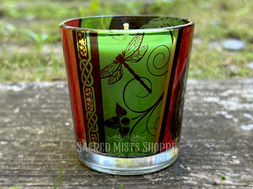 Tree of Life Printed Glass Candle Holder for Votive candles sitting on top of a rock showing the dragonflies with a candle resting inside the votive cup for demonstration. Candle not included.